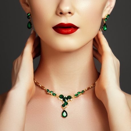 Elegant fashionable woman with jewelry. Beautiful woman with emerald necklace. Young beauty model with emerald pendant. Jewellery and accessories. Fashion and beauty salon. Perfect lip makeup